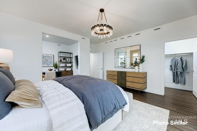 bedroom with a chandelier, a closet, and dark wood-type flooring