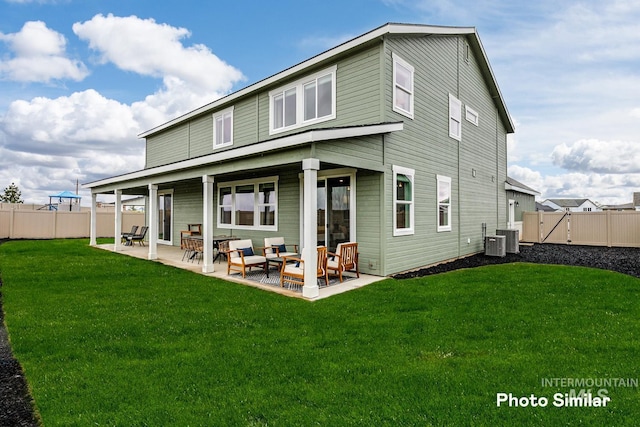 back of house featuring a patio area, outdoor lounge area, a yard, and central AC unit