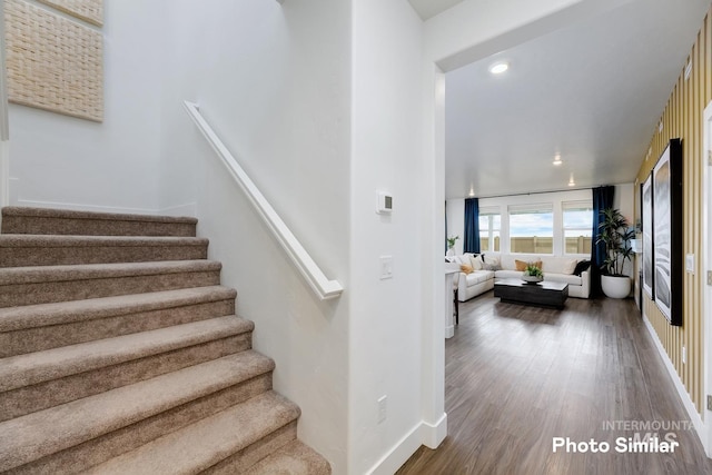 stairs with hardwood / wood-style floors