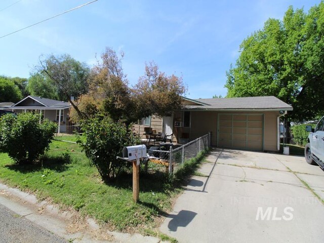 210 W 2nd St, Middleton, ID 83644 - view of front of house with a garage and concrete driveway