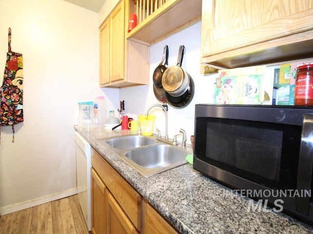 210 W 2nd St, Middleton, ID 83644 - kitchen featuring stainless steel microwave, a sink, light wood-type flooring, baseboards, and white dishwasher