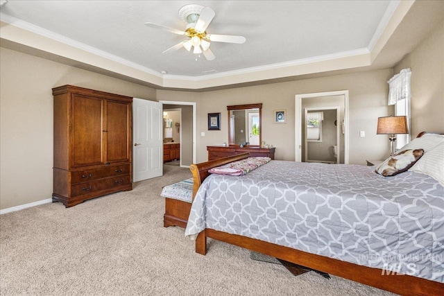 10395 Willis Rd, Middleton, ID 83644 - bedroom with ensuite bathroom, light colored carpet, crown molding, a tray ceiling, and baseboards