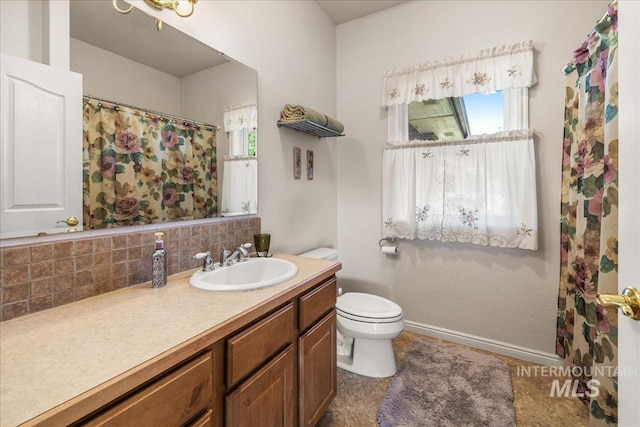10395 Willis Rd, Middleton, ID 83644 - full bath with backsplash, a healthy amount of sunlight, vanity, and toilet
