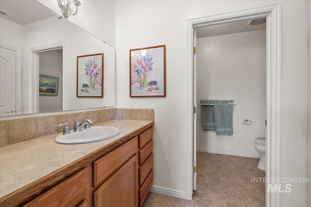 10395 Willis Rd, Middleton, ID 83644 - bathroom with vanity, toilet, baseboards, and visible vents