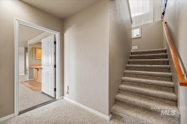 10395 Willis Rd, Middleton, ID 83644 - staircase with carpet, baseboards, and a textured wall