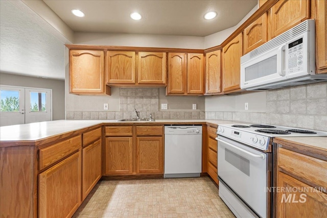 10395 Willis Rd, Middleton, ID 83644 - kitchen featuring a peninsula, light countertops, decorative backsplash, and white appliances