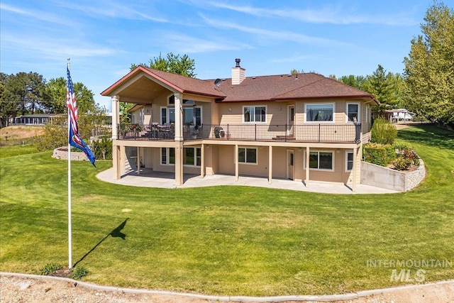 10395 Willis Rd, Middleton, ID 83644 - back of house with a patio area, a wooden deck, a chimney, and a lawn