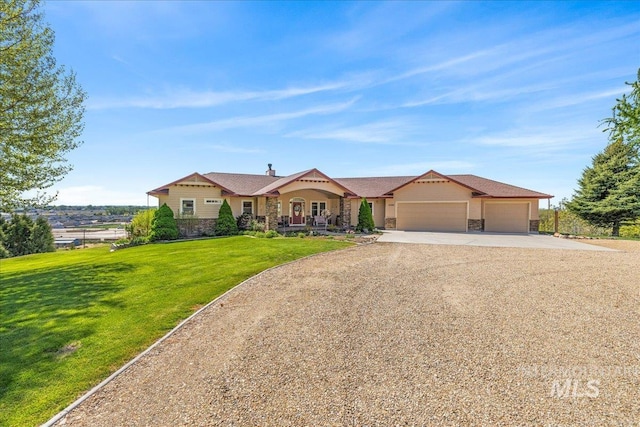10395 Willis Rd, Middleton, ID 83644 - view of front of property with dirt driveway, a front yard, a garage, and stone siding