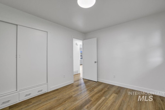 357 Pierce St, Twin Falls, ID 83301 - unfurnished bedroom with wood finished floors, baseboards, and a closet