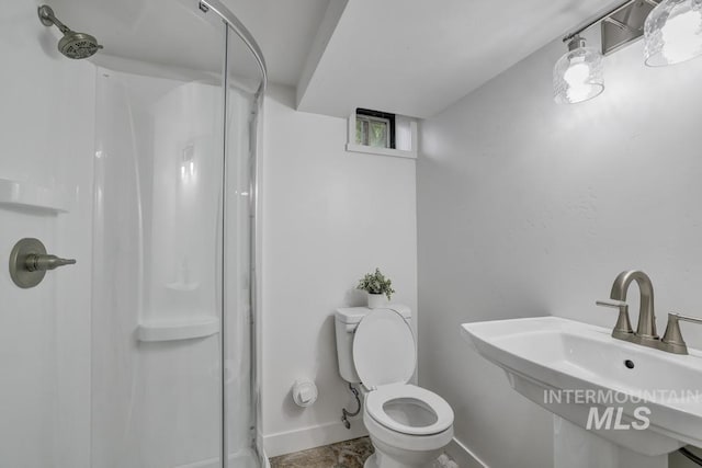 357 Pierce St, Twin Falls, ID 83301 - bathroom featuring a stall shower, a sink, baseboards, and toilet