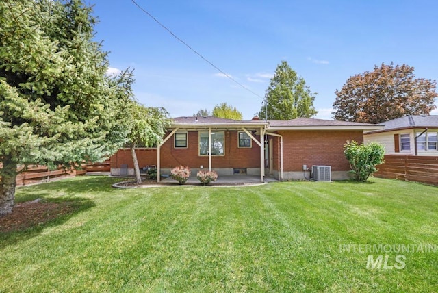 357 Pierce St, Twin Falls, ID 83301 - back of property featuring central AC, a patio area, and brick siding
