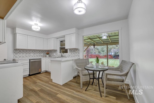 357 Pierce St, Twin Falls, ID 83301 - kitchen with dishwasher, backsplash, light wood-style flooring, white cabinetry, and light countertops