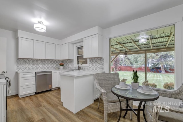 357 Pierce St, Twin Falls, ID 83301 - kitchen with dishwasher, a sink, decorative backsplash, light countertops, and white cabinets
