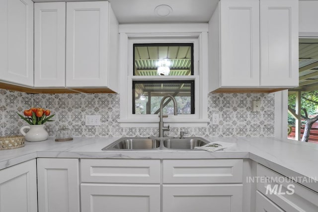 357 Pierce St, Twin Falls, ID 83301 - kitchen featuring a sink, white cabinets, light countertops, and tasteful backsplash