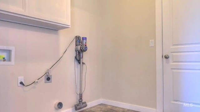 laundry room featuring baseboards, hookup for a washing machine, cabinet space, and electric dryer hookup