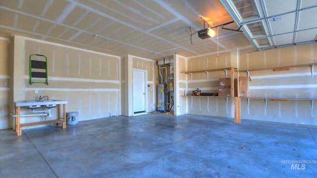 garage featuring a garage door opener and water heater