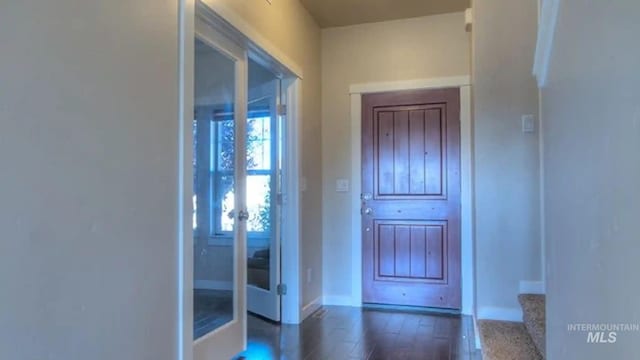 doorway with french doors, stairway, baseboards, and wood finished floors