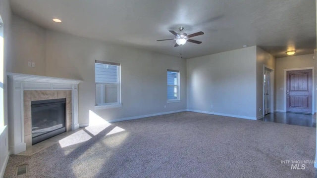 unfurnished living room with carpet floors, a fireplace, and baseboards