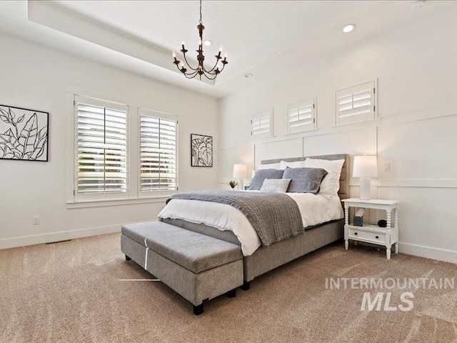 bedroom featuring a raised ceiling, a notable chandelier, recessed lighting, carpet flooring, and baseboards