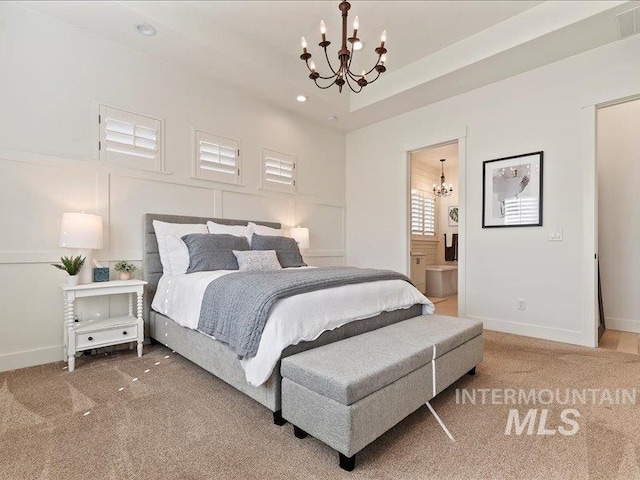 bedroom with carpet, baseboards, and a chandelier