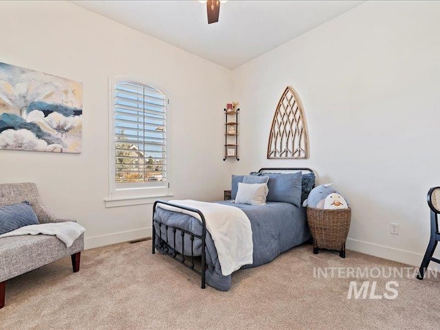 carpeted bedroom with a ceiling fan and baseboards