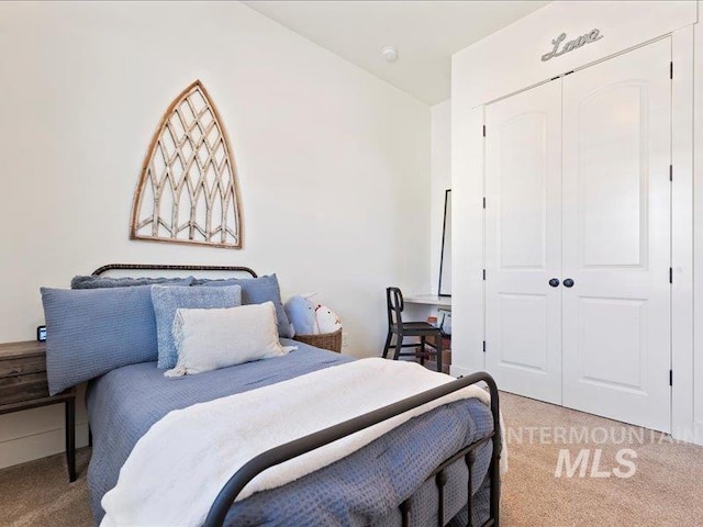 bedroom featuring a closet and light carpet