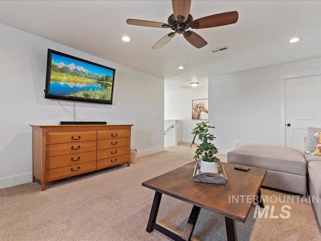 living room with recessed lighting, visible vents, baseboards, and light colored carpet