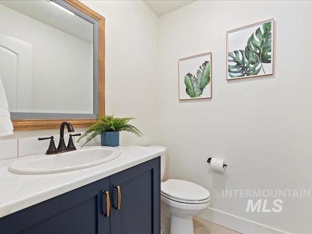 bathroom featuring toilet and vanity