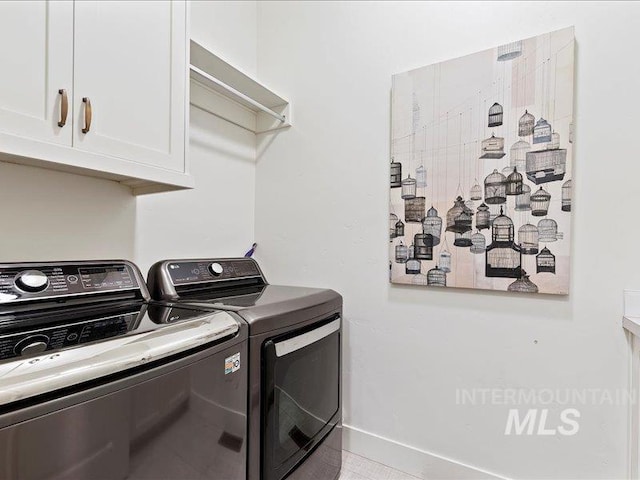 laundry room featuring cabinet space and washing machine and clothes dryer