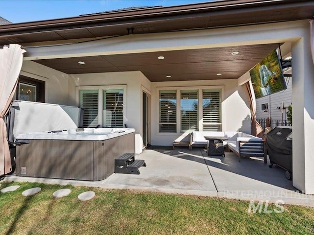 view of patio / terrace featuring outdoor lounge area, area for grilling, and a hot tub