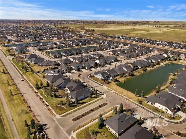 drone / aerial view with a residential view and a water view