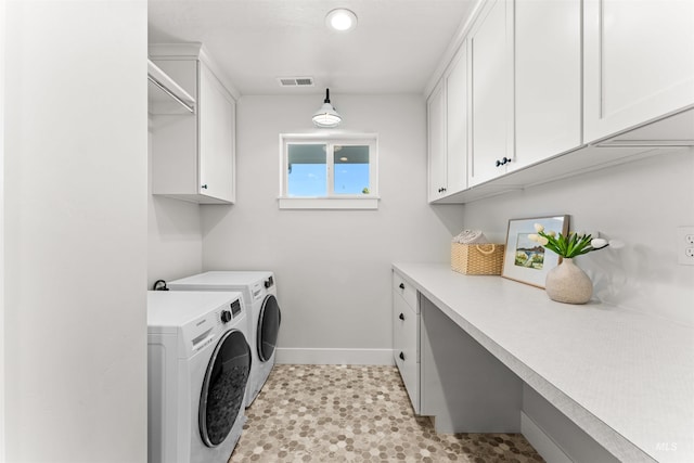washroom featuring light floors, independent washer and dryer, visible vents, baseboards, and cabinet space