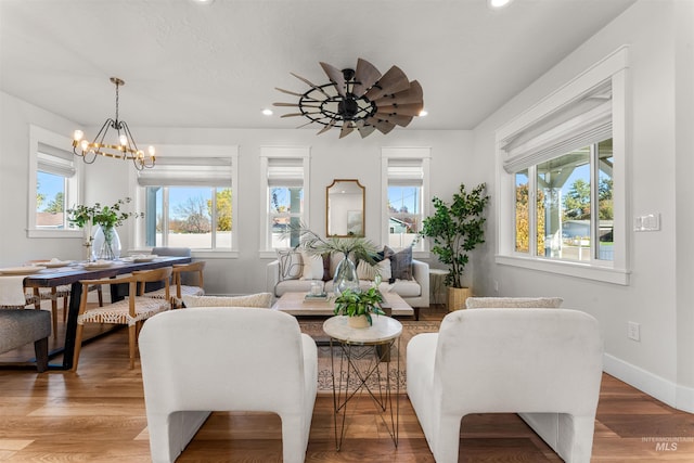 sitting room featuring light wood-style floors, a notable chandelier, baseboards, and recessed lighting