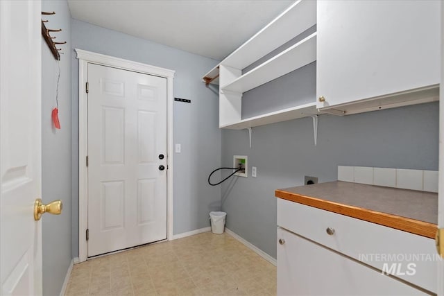 1600 Peregrine, Mountain Home, ID 83647 - laundry room with electric dryer hookup, cabinet space, hookup for a washing machine, and baseboards