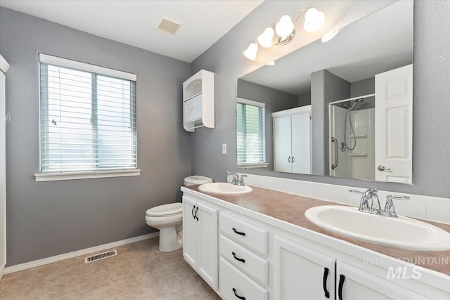 1600 Peregrine, Mountain Home, ID 83647 - bathroom featuring a shower, double vanity, toilet, and baseboards