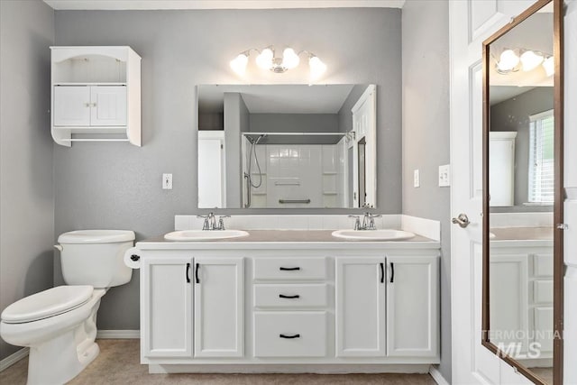 1600 Peregrine, Mountain Home, ID 83647 - full bathroom featuring toilet, a shower, baseboards, and double vanity