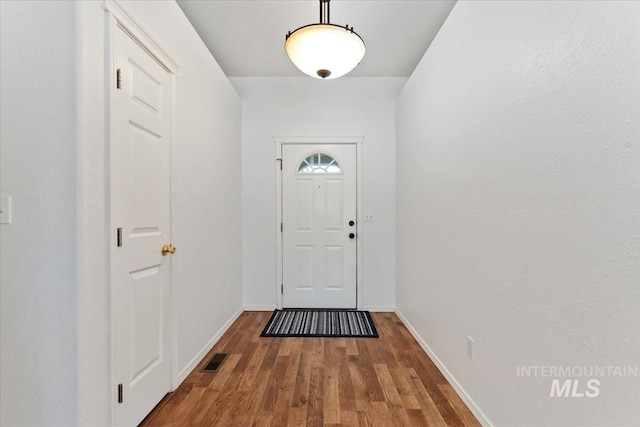 1600 Peregrine, Mountain Home, ID 83647 - doorway with wood finished floors and baseboards