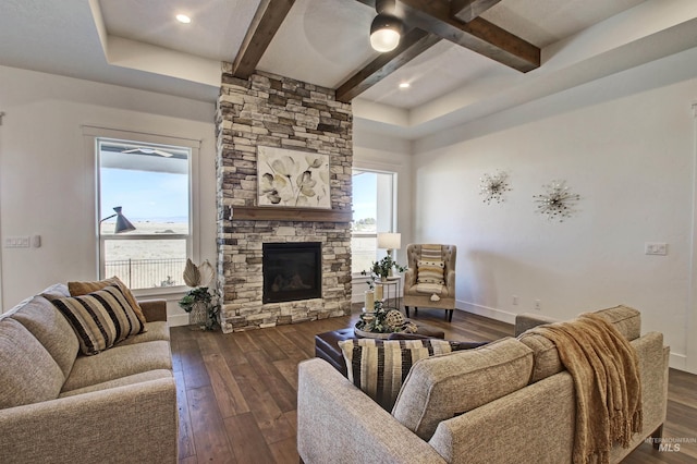 living room featuring dark wood-type flooring, a fireplace, and beamed ceiling