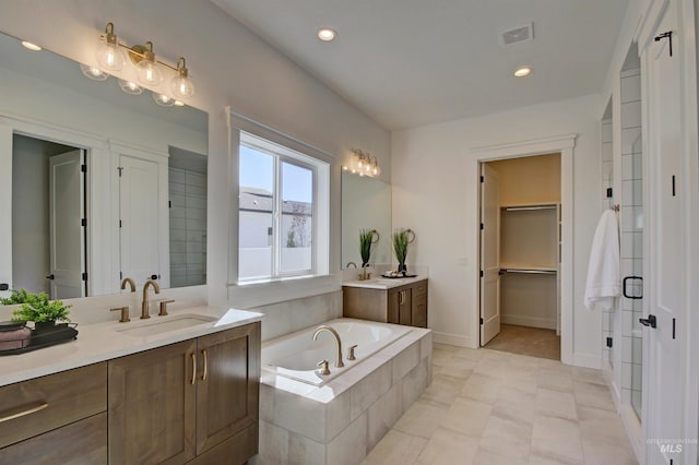 bathroom featuring vanity and separate shower and tub