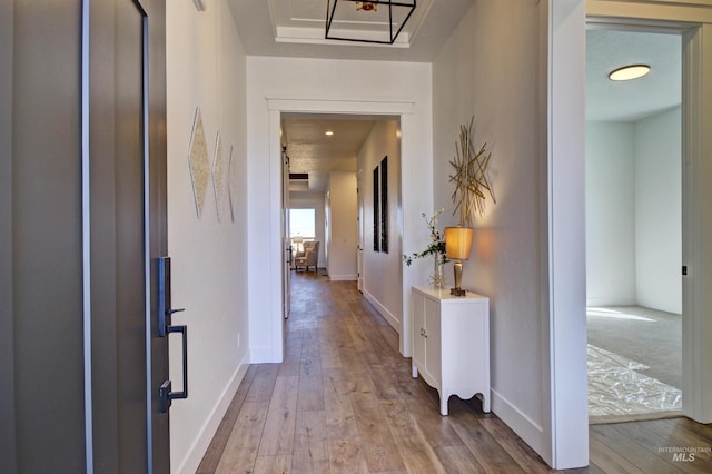 corridor with light hardwood / wood-style flooring