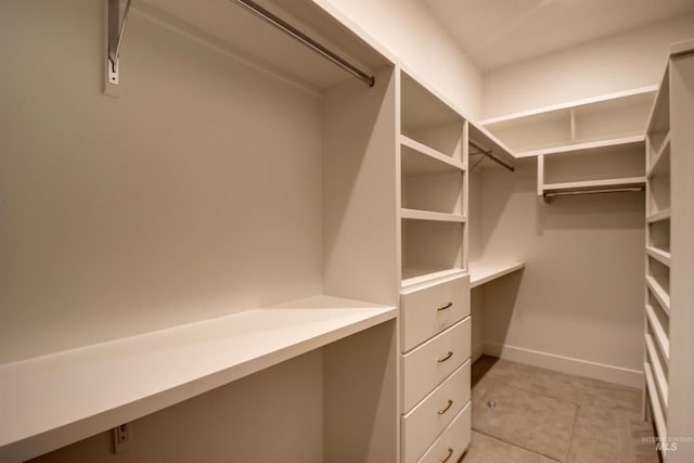 walk in closet featuring light tile patterned floors