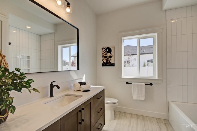 full bathroom featuring tiled shower / bath combo, vanity, and toilet