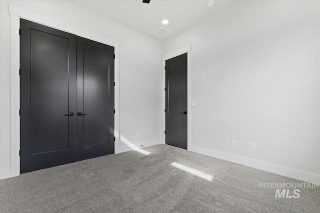 unfurnished bedroom with recessed lighting, visible vents, baseboards, a closet, and carpet