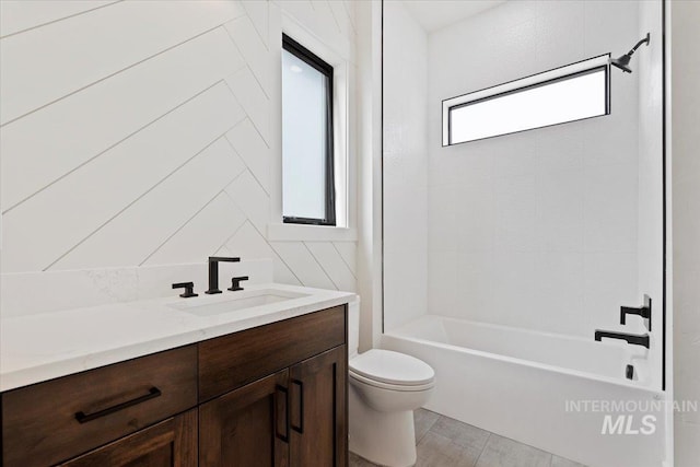 bathroom with toilet, bathing tub / shower combination, and vanity