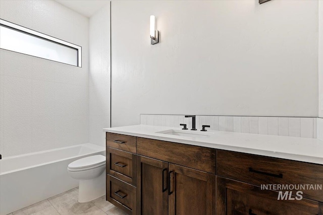 bathroom with tile patterned flooring, vanity, and toilet