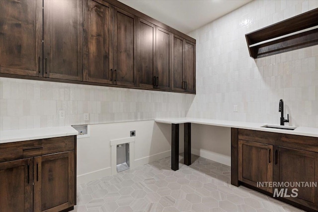 washroom with washer hookup, light tile patterned floors, cabinet space, hookup for an electric dryer, and a sink