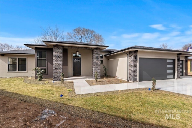 prairie-style home with an attached garage, driveway, a front yard, and brick siding