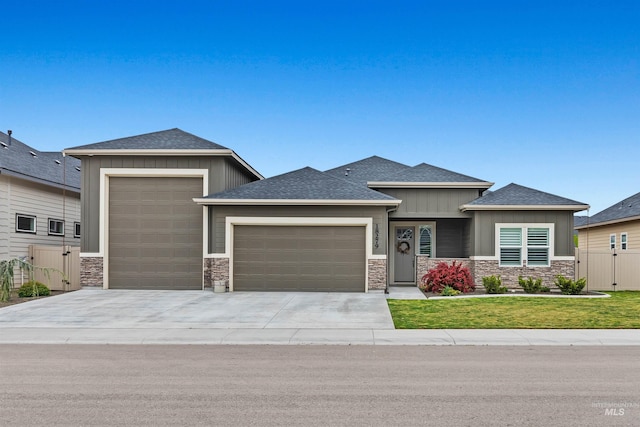 18279 N Tulip Ave, Nampa, ID 83687 - prairie-style home with concrete driveway, an attached garage, board and batten siding, and stone siding