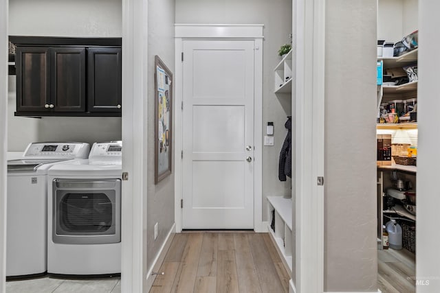 18279 N Tulip Ave, Nampa, ID 83687 - clothes washing area featuring washer and clothes dryer, cabinet space, and light wood finished floors