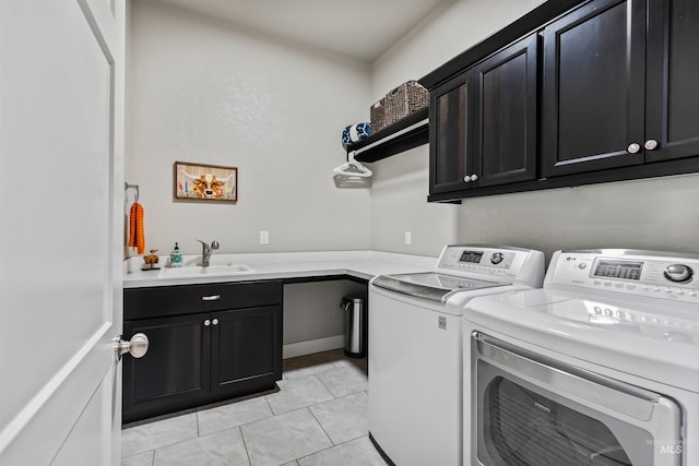 18279 N Tulip Ave, Nampa, ID 83687 - clothes washing area with a sink, light tile patterned floors, cabinet space, and washer and clothes dryer